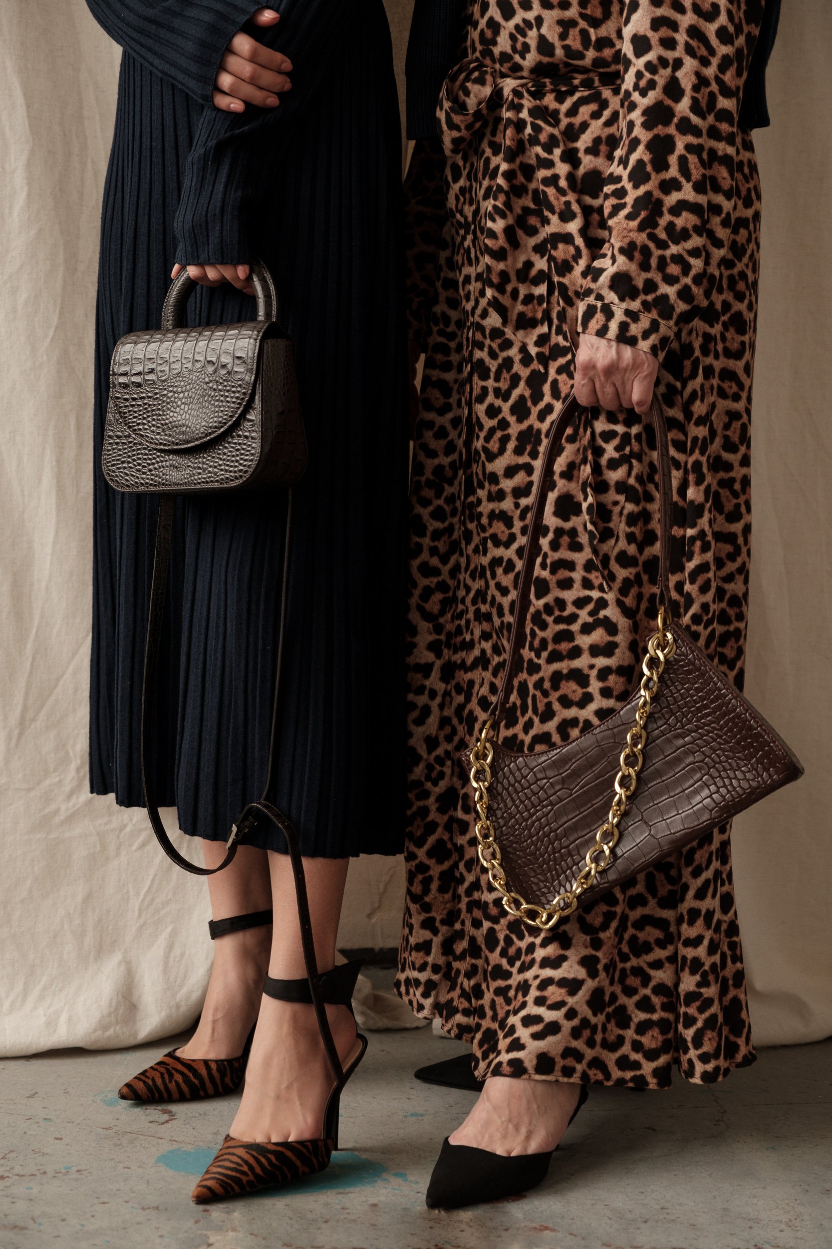 Elegant Mom and Daughter in Dresses and Shoes Holding Bags